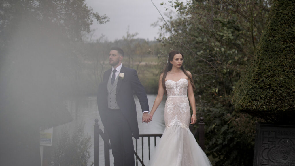 Bride & groom by lake