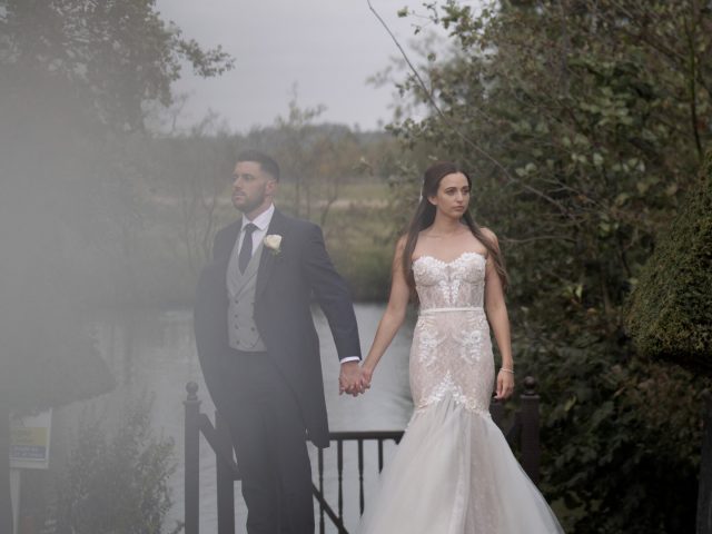 Bride & groom by lake