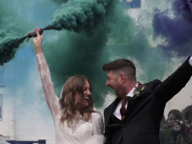 Bride and Groom walking with smoke bombs